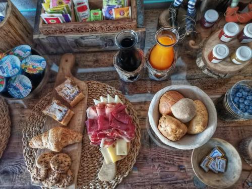 泰穆B&B Le Ciaf的一张木桌,上面放着食物和面包