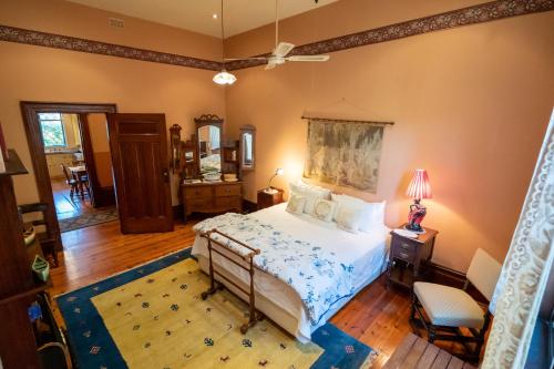 阿德莱德巴克斯顿庄园酒店的一间卧室配有一张床和一张带台灯的桌子