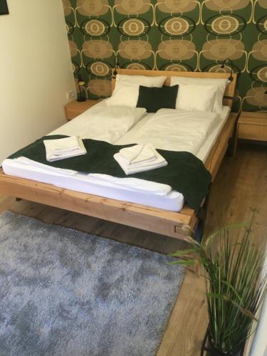 维斯普雷姆Boróka Apartman Belváros的卧室内的一张带白色床单和枕头的床