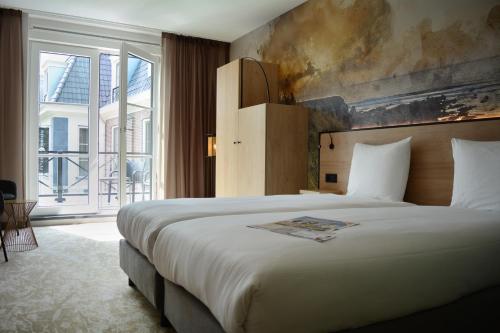 Fletcher Strandhotel Haamstede客房内的一张或多张床位