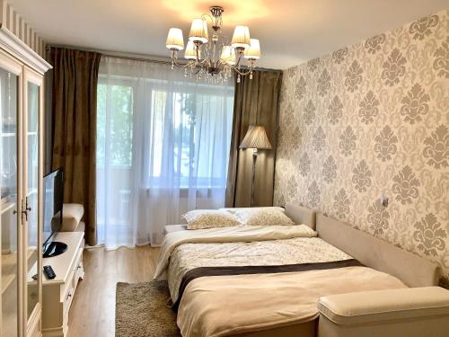 马热伊基艾Venta apartament的一间卧室配有两张床和吊灯。