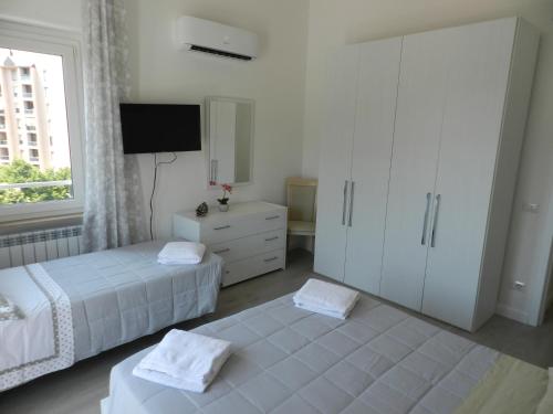佩鲁贾Appartamenti Via Cortonese 1的一间卧室设有两张床和大窗户