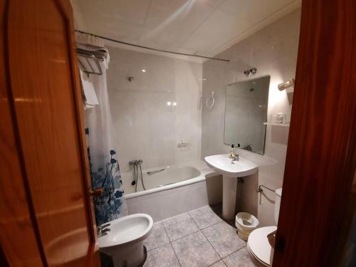 阿尔巴塞特阿尔巴旅馆的浴室配有盥洗盆、卫生间和浴缸。