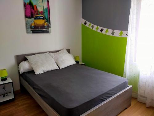 特雷沃 - 特雷吉涅克A 5 mn à pied de la plage的一间卧室配有一张带绿色墙壁的床