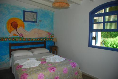 伊利亚贝拉希岛旅馆的一间卧室配有一张壁画床