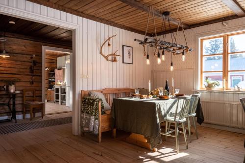 耶利瓦勒Taiga Forest Lodge的一间用餐室,在房间内配有桌子