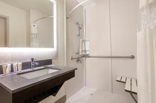 北小石城Country Inn & Suites by Radisson, North Little Rock, AR的一间带水槽和淋浴的浴室