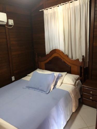 沙帕达-杜斯吉马朗伊斯雅尔丁达沙帕达旅馆的一张白色的床,配有木制床头板和窗户