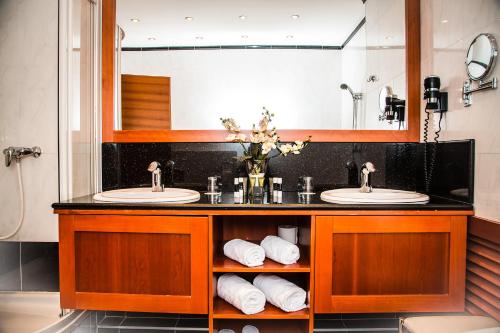 维也纳Hotel Corvinus Vienna - Newly Renovated的一间带两个盥洗盆和大镜子的浴室