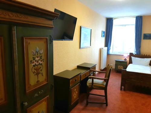 加尔米施-帕滕基兴威尔登菲尔赛霍夫酒店的酒店客房配有书桌和床。