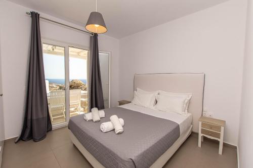 普拉迪斯亚罗斯Lofos Apartments的一间卧室配有一张床,上面有两条毛巾