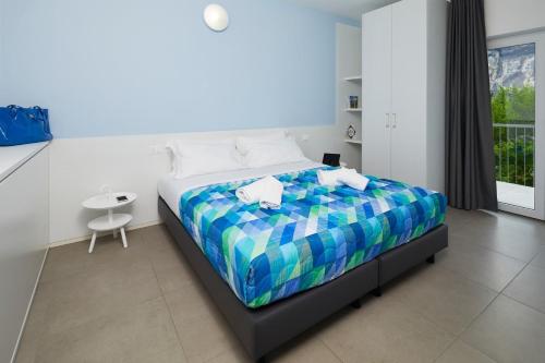 托尔博莱Appartamenti Villa al Fiume的一间卧室配有一张带彩色床罩的床