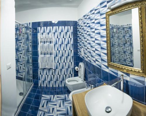 维耶特里Blu Marina的浴室拥有蓝色和白色的瓷砖墙壁和水槽