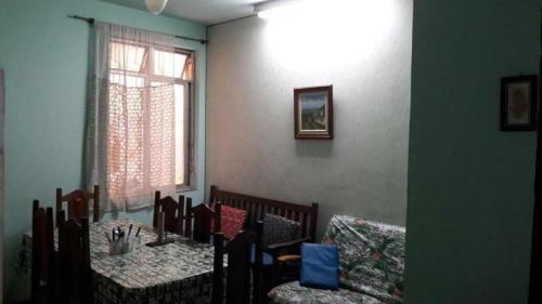 里约热内卢Hostel Jandira的一间带2张桌子和椅子的用餐室以及窗户。