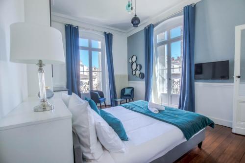 波尔多Magnifique appartement avec 3 chambres en Hypercentre的一间卧室配有一张蓝色墙壁和窗户的床