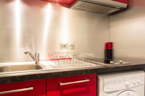 第戎Appartement - Petit Buffon的厨房配有水槽和碗碟干燥架