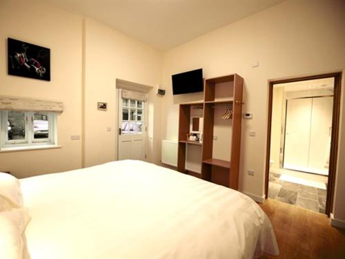 什鲁斯伯里THE COACHING BARNS的卧室配有白色的床和窗户。