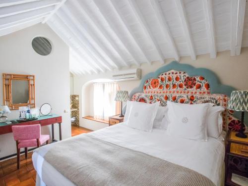 塔里法La Sacristía的一间卧室配有一张白色大床和橙色床头板