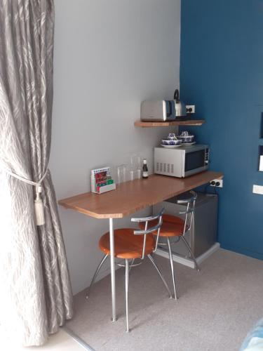 凯里凯里J&D Cottage的一张桌子,房间配有两把椅子和微波炉