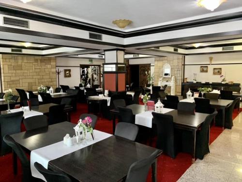KłobuckNocowanie Restauracja Wenecka的一间设有黑桌和黑椅子的餐厅