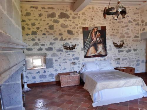 内拉克Château de Cauderoue的卧室配有一张床,墙上挂有绘画作品