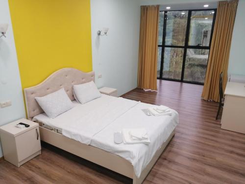 伊杰万Belleville的一间卧室设有一张床和黄色的墙壁