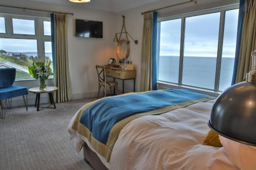 DownderryInn on the Shore的卧室配有一张床、一张书桌和窗户。