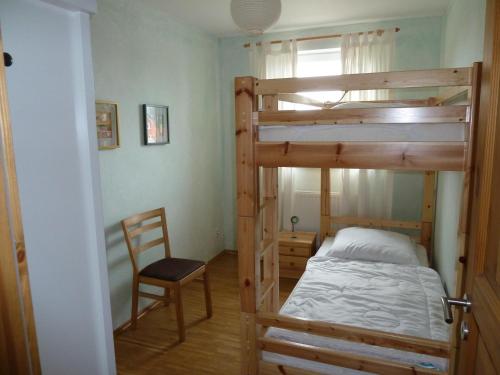 格洛韦Appartement Alt Glowe的一间卧室配有双层床和椅子