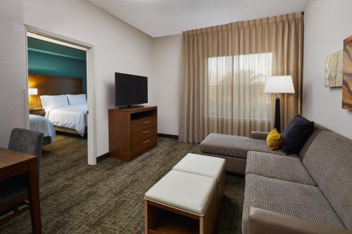奥兰多奥兰多南驻桥套房酒店的酒店客房设有一张沙发和一张床