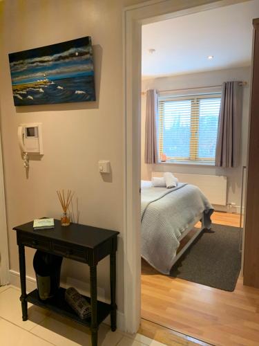 都柏林Boden Heath的一间卧室配有一张床、一张桌子和一个窗户。
