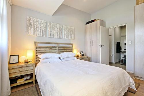 约翰内斯堡The Space的卧室配有一张带两个枕头的大白色床