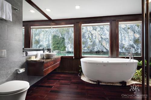 下龙湾Orchid Classic Cruise的一间带大浴缸和窗户的浴室