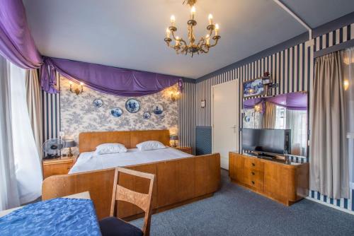 莱顿新密涅瓦莱顿城市酒店的一间卧室配有一张大床和电视