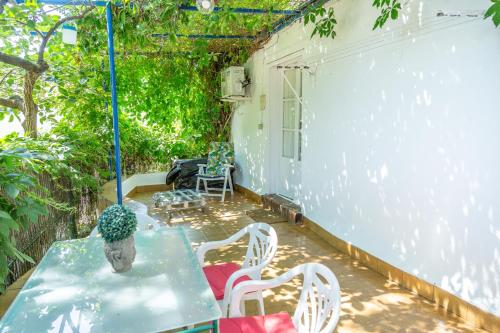 阿拉哈尔Casita Collado 3的庭院配有桌子、白色椅子和桌子