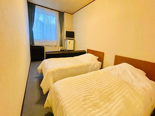 Nangoku Hotel客房内的一张或多张床位