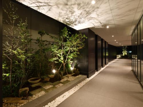 仙台Hotel Keihan Sendai的建筑一侧的走廊上,有植物