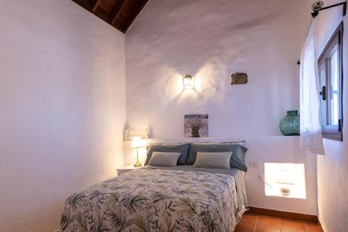 IsoraCasa Elba的卧室配有白色墙壁上的床铺