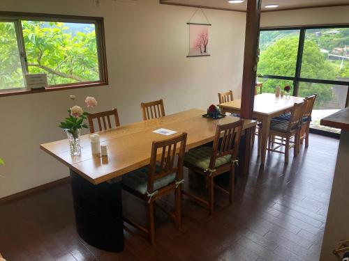 田边市旅籠まさら HATAGO MaSaRa的用餐室配有大型木桌和椅子