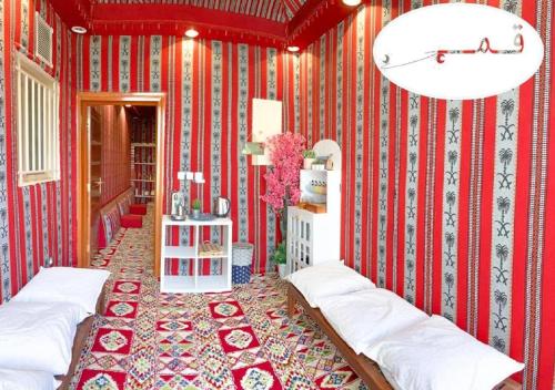 塔伊夫Shams W Qamar Chalets的红色的房间,有红色和白色条纹的墙壁