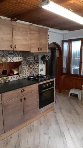 奇萨瓦玛兰科白塔斯坦帕度假屋的厨房配有木制橱柜和炉灶烤箱。