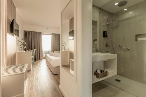 卡罗拉卡罗拉度假酒店的带淋浴和盥洗盆的浴室以及1张床。
