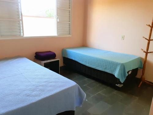 坎皮纳斯Franca Maya Hostel的带窗户和两张床的宿舍间内的两张床