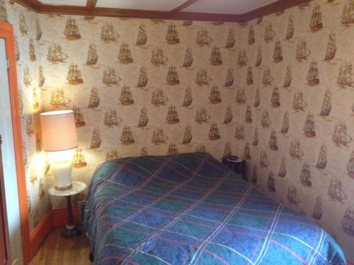 渥太华奥伯格艺术住宿加早餐酒店的一间卧室配有一张床,墙上挂着帆板