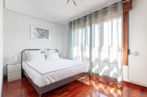 巴拉卡Precioso apartamento cerca de Bilbao Exhibition Center -BEC-, Bilbao y playas的一间卧室设有一张床和一个大窗户