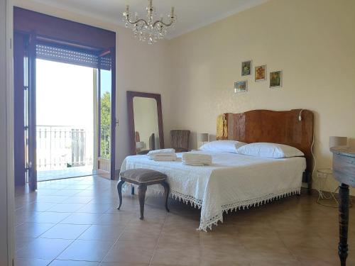 瓦尔德利切Il Ficodindia bianco-Appartamento con terrazza的一间卧室配有一张大床和一个吊灯。