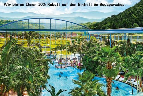 伦茨基希Hotel Hochfirst的棕榈树和桥梁度假村的游泳池