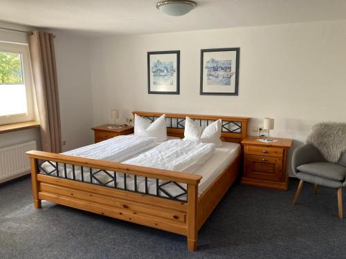 施马伦贝格奥托弗利恩沃农旅馆的一间卧室配有一张大型木床和椅子