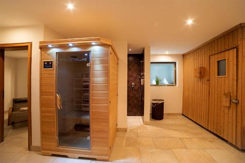 梅明根德瑞塞尔公园酒店的设有带木墙的浴室内的步入式淋浴间