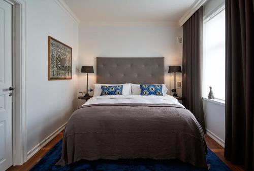 雷克雅未克Sand Hotel by Keahotels的一间卧室设有一张大床和大窗户