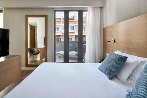 萨拉戈萨中心文奇酒店客房内的一张或多张床位
